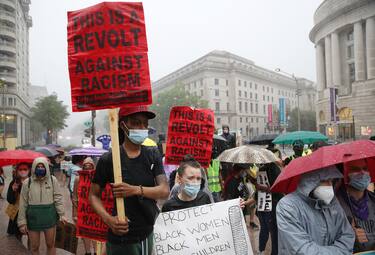 WASHINGTON, DC - JUNE 05: Demonstrators march in the rain during a peaceful protest against police brutality on June 5, 2020 in Washington, DC. Protests in cities throughout the country have been largely peaceful in the wake of the death of George Floyd, a black man, who died while in police custody in Minneapolis on May 25. (Photo by Win McNamee/Getty Images)