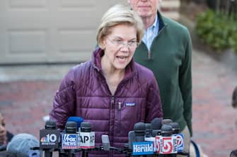 CAMBRIDGE, MA - MARCH 05:  Democratic presidential candidate Sen. Elizabeth Warren (D-MA), with husband Bruce Mann, announces that she is dropping out of the presidential race during a media availability outside of her home on March 5, 2020 in Cambridge, Massachusetts.  (Photo by Scott Eisen/Getty Images)