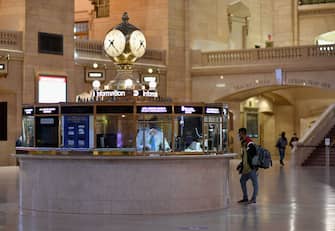 A commuter stands at an information booth at Grand Central Station during morning rush hour on June 8, 2020 in New York City. - Today New York City enters "Phase 1" of a four-part reopening plan after spending more than two months under lockdown. New York City is the final region in the state to reopen its economy. (Photo by Angela Weiss / AFP) (Photo by ANGELA WEISS/AFP via Getty Images)
