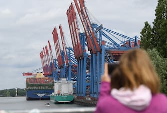 HAMBURG, GERMANY - JUNE 07: A person takes a picture of the HMM Algeciras, currently the world's largest container ship, arrives on its maiden voyage on June 07, 2020 in Hamburg, Germany. The ship is 399.9 meters long and 61 meters wide, and has a nominal capacity to transport 23,964 containers. It is the first in a series of twelve ships in the 24,000 TEU class and was built in South Korea. (Photo by Stuart Franklin/Getty Images)