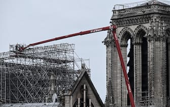 Workers are seen during the first day of the dismantling operations of the scaffolding at the Notre-Dame Cathedral in Paris on June 8, 2020 that was damaged in the April 15, 2019 blaze. (Photo by Philippe LOPEZ / AFP) (Photo by PHILIPPE LOPEZ/AFP via Getty Images)