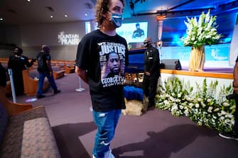 Mourners pass by the casket of George Floyd during a public visitation for Floyd at the Fountain of Praise church Monday, June 8, 2020, in Houston. (Photo by David J. Phillip / POOL / AFP) (Photo by DAVID J. PHILLIP/POOL/AFP via Getty Images)