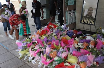 HOUSTON, TEXAS - JUNE 08: Flowers are placed in front of a picture of George Floyd during his public viewing at the Fountain of Praise church on June 8, 2020 in Houston, Texas. George Floyd died on May 25th when he was in Minneapolis police custody, sparking nationwide protests. (Photo by Joe Raedle/Getty Images)