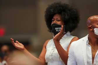 A woman claps during the funeral service for George Floyd on June 9, 2020, at The Fountain of Praise Church in Houston. - George Floyd will be laid to rest Tuesday in his Houston hometown, the culmination of a long farewell to the 46-year-old African American whose death in custody ignited global protests against police brutality and racism.Thousands of well-wishers filed past Floyd's coffin in a public viewing a day earlier, as a court set bail at $1 million for the white officer charged with his murder last month in Minneapolis. (Photo by Godofredo A. VASQUEZ / POOL / AFP) (Photo by GODOFREDO A. VASQUEZ/POOL/AFP via Getty Images)