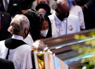 Family members of George Floyd pause at the casket during a funeral service for Floyd at The Fountain of Praise Church on June 9, 2020, in Houston. - George Floyd will be laid to rest Tuesday in his Houston hometown, the culmination of a long farewell to the 46-year-old African American whose death in custody ignited global protests against police brutality and racism.Thousands of well-wishers filed past Floyd's coffin in a public viewing a day earlier, as a court set bail at $1 million for the white officer charged with his murder last month in Minneapolis. (Photo by David J. Phillip / AFP) (Photo by DAVID J. PHILLIP/AFP via Getty Images)
