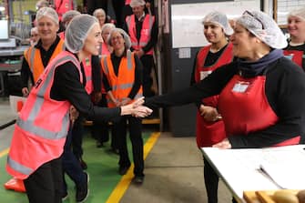 TAURANGA, NEW ZEALAND - JUNE 09: Prime Minister Jacinda Ardern (L) meets and talks to staff during the visit to Trevelyanâ  s Kiwifruit and Avocado Packhouse on June 09, 2020 in Tauranga, New Zealand. COVID-19 restrictions were lifted from midnight as New Zealand moved to COVID-19 Alert Level 1 as the government confirmed there are zero active cases in the country. The lifting of restrictions under Alert Level 1 will see life mostly return to normal in New Zealand, however strict border measures will remain with mandatory isolation and quarantine for any overseas arrivals. New Zealanders are also being asked to keep diaries in the event of a second wave of infections. (Photo by Michael Bradley/Getty Images)