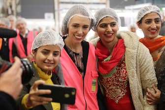 TAURANGA, NEW ZEALAND - JUNE 09: Prime Minister Jacinda Ardern (C) meets and talks to staff during the visit to Trevelyanâ  s Kiwifruit and Avocado Packhouse on June 09, 2020 in Tauranga, New Zealand. COVID-19 restrictions were lifted from midnight as New Zealand moved to COVID-19 Alert Level 1 as the government confirmed there are zero active cases in the country. The lifting of restrictions under Alert Level 1 will see life mostly return to normal in New Zealand, however strict border measures will remain with mandatory isolation and quarantine for any overseas arrivals. New Zealanders are also being asked to keep diaries in the event of a second wave of infections. (Photo by Michael Bradley/Getty Images)