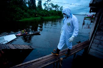 A health worker from the city of Melgaco arrives to a small riverside community at the Quara river, where eight families live without electricity, to give medical care to its residents amid concern over the spread of the COVID-19 coronavirus, in the southwest of Marajo Island, state of Para, Brazil, on June 9, 2020. (Photo by TARSO SARRAF / AFP) (Photo by TARSO SARRAF/AFP via Getty Images)