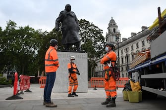 LONDON, ENGLAND - JUNE 11: Workers erect a protective barrier around the statue of Winston Churchill in Parliament Square in anticipation of protests tomorrow on June 11, 2020 in London, England. Outside the Houses of Parliament, the statue of former Prime Minister Winston Churchill was spray-painted with the words "was a racist" amid anti-racism protests over the weekend. In Bristol, protesters toppled a statue of Edward Colston, a 17th-century slave-trader, and tossed it into the harbor. (Photo by Peter Summers/Getty Images)