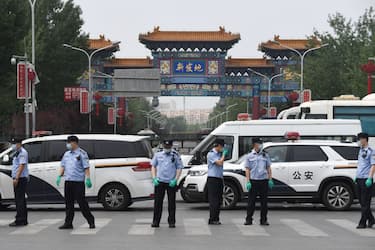 Chinese police guard the entrance to the closed Xinfadi market in Beijing on June 13, 2020. - Eleven residential estates in south Beijing have been locked down due to a fresh cluster of coronavirus cases linked to the Xinfadi meat market, officials said on June 13. (Photo by GREG BAKER / AFP) (Photo by GREG BAKER/AFP via Getty Images)