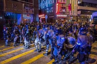 HONG KONG, CHINA - OCTOBER 31: Riot police stand guard on the street during Halloween celebration on October 31, 2019 in Hong Kong, China. Hong Kong slipped into a technical recession on Thursday after anti-government demonstrations stretched into its fifth month while protesters continue to call for Hong Kong's Chief Executive Carrie Lam to meet their remaining demands since the controversial extradition bill was withdrawn, which includes an independent inquiry into police brutality, the retraction of the word "riot" to describe the rallies, and genuine universal suffrage. (Photo by Billy H.C. Kwok/Getty Images)