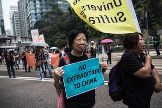 Protesters march along a street during a rally in Hong Kong on March 31, 2019 to protest against the government's plans to approve extraditions with mainland China, Taiwan and Macau. - Critics fear any extradition agreement could leave both business figures and dissidents in Hong Kong vulnerable to China's politicised courts, fatally undermining a business hub that has thrived off its reputation for a transparent and independent judiciary. (Photo by Dale DE LA REY / AFP)        (Photo credit should read DALE DE LA REY/AFP via Getty Images)