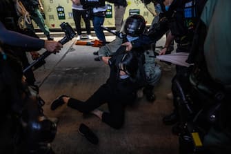 HONG KONG, CHINA - JUNE 9: Riot police officers arrest a pro-democracy protester during a march in the Central district of Hong Kong on June 9, 2020 in Hong Kong, China. The city marks the one-year anniversary since pro-democracy protests erupted following opposition to a bill allowing extraditions to mainland China. (Photo by Billy H.C. Kwok/Getty Images)