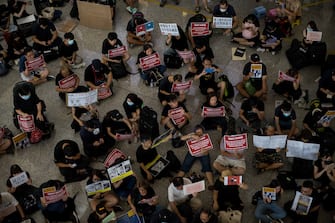 HONG KONG, CHINA - JULY 26: Protesters rally against a controversial extradition bill in the arrivals hall of the international airport on July 26, 2019 in Hong Kong, China. Pro-democracy protesters have continued weekly rallies on the streets of Hong Kong against a controversial extradition bill since 9 June as the city plunged into crisis after waves of demonstrations and several violent clashes. Hong Kong's Chief Executive Carrie Lam apologized for introducing the bill and recently declared it "dead", however protesters have continued to draw large crowds with demands for Lam's resignation and completely withdraw the bill. (Photo by Billy H.C. Kwok/Getty Images)