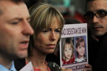 Gerry (L) and Kate (C) McCann speak to journalists holding signs portraiting their missing daughter Madeleine reading "don't give me up" as they leave the Tribunal Civil de Lisboa in Lisbon on February 10, 2010, after the last court session of their libel action against Goncalo Amaral the Portuguese police officer who led the initial probe in the case. Kate and Gerry McCann are suing Amaral for 1.2 million euros (1.7 million dollars) for defamation over allegations he made in a book that their daughter was dead and that they were involved in her disappearance. Madeleine went missing from a holiday apartment in the Algarve resort of Praia da Luz on May 3, 2007, a few days before her fourth birthday, as her parents and their friends dined at a nearby restaurant. AFP PHOTO/ FRANCISCO LEONG (Photo credit should read FRANCISCO LEONG/AFP via Getty Images)