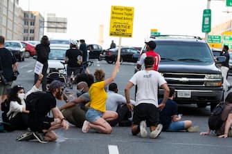 epa08487480 Protesters shut down Interstate 395, a highway that runs through the nation's capital, during a protest to demand justice for George Floyd and for racial equality, in Washington, DC, USA, 15 June 2020. Protesters kneeled on the ground and forced traffic to stop. The death of George Floyd while in police custody in Minneapolis has sparked global protests demanding policing reform.  EPA/MICHAEL REYNOLDS