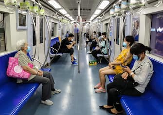 BEIJING, CHINA - JUNE 18: (EDITOR'S NOTE: Photo was taken with mobile phone camera.) Commuters wear protective masks and keep their distance on the subway on June 18, 2020 in Beijing, China. The authorities in Beijing have begun an operation to contain a potential second wave of coronavirus after 159 new cases were detected, the most in nine weeks.  (Photo by Lintao Zhang/Getty Images)
