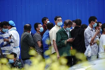 BEIJING, CHINA - JUNE 18:  Citizens who visited or live near Xinfadi Market queue for a nucleic acid test on June 18, 2020 in Beijing, China. The authorities in Beijing have begun an operation to contain a potential second wave of coronavirus after 159 new cases were detected, the most in nine weeks.  (Photo by Lintao Zhang/Getty Images)