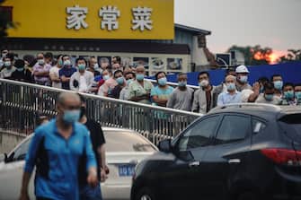 BEIJING, CHINA - JUNE 18:  Citizens who visited or live near Xinfadi Market queue for a nucleic acid test on June 18, 2020 in Beijing, China. The authorities in Beijing have begun an operation to contain a potential second wave of coronavirus after 159 new cases were detected, the most in nine weeks.  (Photo by Lintao Zhang/Getty Images)
