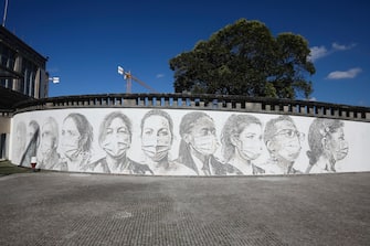 epa08495716 A view of a mural at Sao Joao Hospital in Porto, Portugal, 19 June 2020. The artwork carved by Portuguese street artist Alexandre Farto, tag-named as VHILS, depicts the faces of ten healthcare workers and is a tribute to all medical and health workers who are looking after those in need amid the ongoing pandemic of the COVID-19 disease caused by the SARS-CoV-2 coronavirus.  EPA/JOSE COELHO