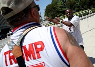TULSA, OKLAHOMA - JUNE 18: Nicholas Winford (R) debates Trump supporter Randall Thom (L), on the racial policies of U.S. President Donald Trump outside the BOK Center June 18, 2020 in Tulsa, Oklahoma. Trump is scheduled to hold his first political rally since the start of the coronavirus pandemic at the BOK Center on Saturday while infection rates in the state of Oklahoma continue to rise.  (Photo by Win McNamee/Getty Images)