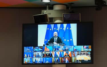 epa08495145 A television screen shows European Council President Charles Michel (top) and European Union (EU) leaders (bottom) taking part in a virtual European summit, in Brussels, Belgium, 19 June 2020. In the video conference, the leaders are discussing the creation of a fund to help member states recover from the economic impact of the ongoing COVID-19 pandemic caused by the SARS-CoV-2 coronavirus, as well as lay out a new long-term budget for the bloc.  EPA/OLIVIER HOSLET / POOL