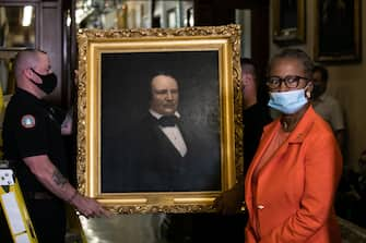 House Clerk Cheryl Johnson looks on as Architect of the Capitol maintenance workers remove a painting of former confederate speaker James Orr of South Carolina, from the east staircase of the Speakers lobby, on Capitol Hill on June 18, 2020. - House Speaker Nancy Pelosi on June 18 ordered the removal from the US Capitol of four portraits of former lawmakers who served in the Confederacy, saying their images symbolize "grotesque racism."  The four outgoing portraits depict 19th century speakers of the House who also served in the Confederacy: Robert Hunter of Virginia, Howell Cobb of Georgia, James Orr of South Carolina, and Charles Crisp of Georgia. (Photo by Graeme Jennings / POOL / AFP) (Photo by GRAEME JENNINGS/POOL/AFP via Getty Images)