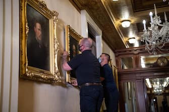 Architect of the Capitol maintenance workers remove a painting of former confederate speaker James Orr of South Carolina, from the east staircase of the Speakers lobby, on Capitol Hill on June 18, 2020. - House Speaker Nancy Pelosi on June 18 ordered the removal from the US Capitol of four portraits of former lawmakers who served in the Confederacy, saying their images symbolize "grotesque racism."  The four outgoing portraits depict 19th century speakers of the House who also served in the Confederacy: Robert Hunter of Virginia, Howell Cobb of Georgia, James Orr of South Carolina, and Charles Crisp of Georgia. (Photo by Nicholas Kamm / POOL / AFP) (Photo by NICHOLAS KAMM/POOL/AFP via Getty Images)