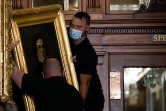 WASHINGTON, DC - JUNE 18: Architect of the Capitol maintenance workers remove a painting of Howell Cobb of Georgia, from the east staircase of the Speakers lobby, on Capitol Hill, on June 18, 2020 in Washington, DC. The portraits of Robert Hunter, James Orr, Howell Cobb and Charles Crisp were removed on the orders of Speaker Nancy Pelosi (D-CA) ahead of the Juneteenth holiday and in the wake of nationwide protests against police brutality and systemic racism. (Photo by Graeme Jennings-Pool/Getty Images)