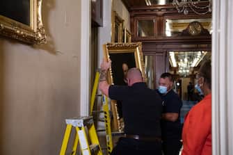 WASHINGTON, DC - JUNE 18: Architect of the Capitol workers remove the portrait of Confederate speaker James Orr from a wall in the Speaker's Lobby of the U.S. Capitol on June 18, 2020 in Washington, DC. The portraits of Robert Hunter, James Orr, Howell Cobb and Charles Crisp were removed on the orders of Speaker Nancy Pelosi (D-CA) ahead of the Juneteenth holiday and in the wake of nationwide protests against police brutality and systemic racism. (Photo by Nicholas Kamm-Pool/Getty Images)