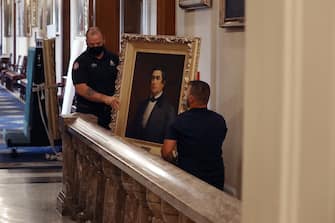 WASHINGTON, DC - JUNE 18: Staff from the Architect of the Capitol remove a portrait of former Speaker of the House Robert Hunter of Virginia (1839-1841), who was a Confederate official, from the Speaker's Lobby in the U.S. Capitol June 18, 2020 in Washington, DC. The portraits of Hunter, James Orr, Howell Cobb and Charles Crisp were removed on the orders of Speaker Nancy Pelosi (D-CA) ahead of the Juneteenth holiday and in the wake of nationwide protests against police brutality and systemic racism. (Photo by Chip Somodevilla/Getty Images)