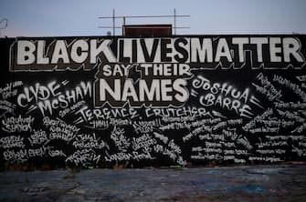 TULSA, OKLAHOMA - JUNE 18: A mural painted on the side of Mad Dog Liquors is shown June 18, 2020 in Tulsa, Oklahoma. The Black Wall Street Massacre occurred in Tulsa in the year 1921 and was one of the worst race riots in the history of the United States where more than 35 square blocks of a predominantly black neighborhood were destroyed in two days of rioting leaving between 150-300 people dead.  (Photo by Win McNamee/Getty Images)