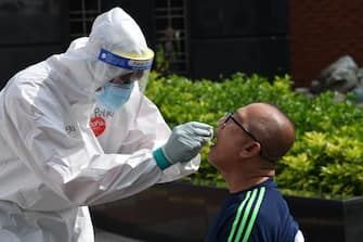 A man gets a free swab test sponsored by the Indonesian National police amid the COVID-19 coronavirus outbreak in Jakarta on June 21, 2020. (Photo by ADEK BERRY / AFP) (Photo by ADEK BERRY/AFP via Getty Images)