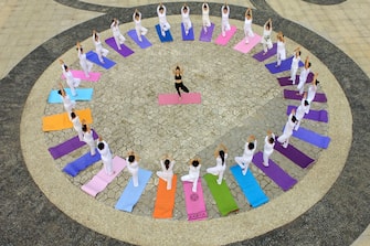 TOPSHOT - This aerial photo shows yoga enthusiasts practising yoga at a park in Handan in China's northern Hebei province on June 19, 2020, ahead of International Yoga Day celebrated annually on June 21. (Photo by STR / AFP) / China OUT (Photo by STR/AFP via Getty Images)
