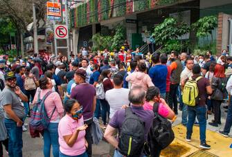 People remain outside buildings in Mexico City during a quake on June 23, 2020 amid the COVID-19 novel coronavirus pandemic. - A 7.1 magnitude quake was registered Tuesday in the south of Mexico, according to the Mexican National Seismological Service. (Photo by CLAUDIO CRUZ / AFP) (Photo by CLAUDIO CRUZ/AFP via Getty Images)