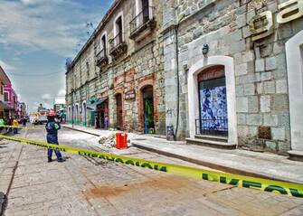 Security tape alerts people of a damaged building after a quake in Oaxaca, Mexico on June 23, 2020. - A 7.1 magnitude quake was registered Tuesday in the south of Mexico, according to the Mexican National Seismological Service. (Photo by PATRICIA CASTELLANOS / AFP) (Photo by PATRICIA CASTELLANOS/AFP via Getty Images)