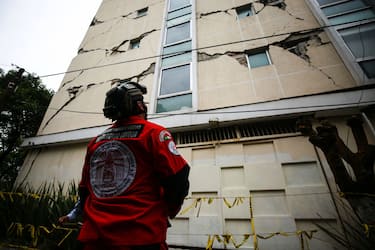 MEXICO CITY, MEXICO - JUNE 23: An urban search and rescue rescuer looks a damage bulding since the 2017 earthquake on June 23, 2020 in Mexico City, Mexico. According to the National Seismological Service a 7.5 magnitude earthquake was registered on Tuesday in Mexico City and in various areas of the country. (Photo by Manuel Velasquez/Getty Images)