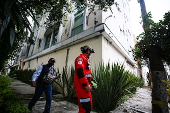MEXICO CITY, MEXICO - JUNE 23: An urban search and rescue rescuer looks a damage bulding since the 2017 earthquake on June 23, 2020 in Mexico City, Mexico. According to the National Seismological Service a 7.5 magnitude earthquake was registered on Tuesday in Mexico City and in various areas of the country. (Photo by Manuel Velasquez/Getty Images)