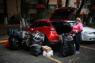 MEXICO CITY, MEXICO - JUNE 23: A resident takes her belongings from her apartment in the Lindavista Housing Unit due to the risk of collapse on June 23, 2020 in Mexico City, Mexico. According to the National Seismological Service a 7.5 magnitude earthquake was registered on Tuesday in Mexico City and in various areas of the country. (Photo by Manuel Velasquez/Getty Images)