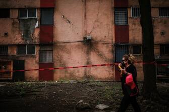 MEXICO CITY, MEXICO - JUNE 23: A woman walks over the back side of the Lindavista Housing Unit, which is at risk of collapse on June 23, 2020 in Mexico City, Mexico. According to the National Seismological Service a 7.5 magnitude earthquake was registered on Tuesday in Mexico City and in various areas of the country. (Photo by Manuel Velasquez/Getty Images)