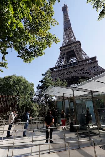 People arrive for the partial reopening of Eiffel Tower on June 25, 2020, in Paris, as France eases lockdown measures taken to curb the spread of the COVID-19 caused by the novel coronavirus. - Tourists and Parisians will again be able to admire the view of the French capital from the Eiffel Tower after a three-month closure due to the coronavirus -- but only if they take the stairs. (Photo by Thomas SAMSON / AFP) (Photo by THOMAS SAMSON/AFP via Getty Images)