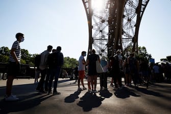 Visitors queue as they wait for the partial reopening of Eiffel Tower on June 25, 2020, in Paris, as France eases lockdown measures taken to curb the spread of the COVID-19 caused by the novel coronavirus. - Tourists and Parisians will again be able to admire the view of the French capital from the Eiffel Tower after a three-month closure due to the coronavirus -- but only if they take the stairs. (Photo by Thomas SAMSON / AFP) (Photo by THOMAS SAMSON/AFP via Getty Images)