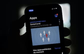 A photo taken on June 26, 2020 shows the tracing smartphone app "SwissCovid" created by the Swiss Federal Institute of Technology Lausanne (EPFL) and designed to trace people potentially infected with COVID-19 that Swiss government rolled out to the public on June 25, 2020. (Photo by Fabrice COFFRINI / AFP) (Photo by FABRICE COFFRINI/AFP via Getty Images)