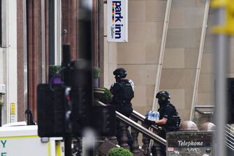 GLASGOW, SCOTLAND - JUNE 26: Police officers walk in through the main entrance of the Park Inn Hotel after reports of three people being killed on June 26, 2020 in Glasgow, Scotland. A knifeman stabbed three people to death in the stairwell of the Park Inn Hotel on West George Street, Glasgow before being shot himself by armed police. The Scottish Police Federation (SPF) said an officer was stabbed during the major incident. (Photo by Jeff J Mitchell/Getty Images)