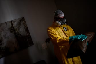 An employee of a private company sanitizes against the spread of the novel coronavirus COVID-19 at a house in Belo Horizonte, state of Minas Gerais, Brazil, on June 26, 2020. - The pandemic has killed at least 487,274 people worldwide since it surfaced in China late last year, according to an AFP tally at 1100 GMT on Friday, based on official sources, while Brazil, the hardest-hit country in Latin America, had close to 55,000 deaths. (Photo by Douglas MAGNO / AFP) (Photo by DOUGLAS MAGNO/AFP via Getty Images)