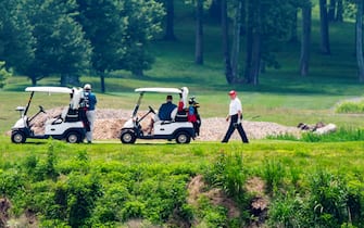 epa08512910 US President Donald J. Trump (R) plays golf at the Trump National Golf Club in Sterling, Virginia, USA, 27 June 2020. On 26 June, Trump abruptly canceled a weekend trip to Bedminster, NJ, tweeting that he 'wanted to stay in Washington, D.C. to make sure LAW & ORDER is enforced.'  EPA/JIM LO SCALZO