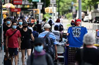 People wearing facemasks walk down a street near Union Square on June 25, 2020 in New York City. - New York businesses opened their doors to returning waves of workers June 22 as the city that was once the epicenter of the global pandemic marked an important milestone in its return to normalcy, even as other US states were seeing an alarming rise in COVID-19 cases. (Photo by Angela Weiss / AFP) (Photo by ANGELA WEISS/AFP via Getty Images)