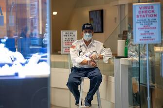 NEW YORK, NEW YORK - JUNE 24: A security guard holds a non contact infrared thermometer at the entrance to a jewelry store in the Diamond District of New York as the city moves into Phase 2 of re-opening following restrictions imposed to curb the coronavirus pandemic on June 24, 2020 in New York City. Phase 2 permits the reopening of offices, in-store retail, outdoor dining, barbers and beauty parlors and numerous other businesses. New York state plans on re-opening in four phases. (Photo by Alexi Rosenfeld/Getty Images)