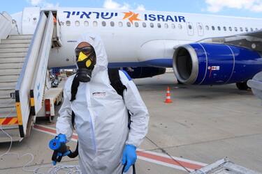 TEL AVIV, ISRAEL - MAY 25: Yair Badash, a maintenance manager at the Israeli low-cost ariline Israir, wears his PPE as he prepares to disinfect an aircraft between flights at Ben Gurion Airport on May 25, 2020 near Tel Aviv, Israel. Israir uses a Boeing and Airbus approved chemical fog that is sprayed on all inner surfaces before the plane is sealed for 45 minutes to disinfect the aircraft from any traces of the Covid-19 corona-virus. (Photo by David Silverman/Getty Images)