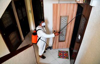 A municipal worker sprays disinfectant in a residential area during a government-imposed nationwide lockdown as a preventive measure against the spread of the COVID-19 coronavirus in Mumbai on March 30, 2020. (Photo by Indranil MUKHERJEE / AFP) (Photo by INDRANIL MUKHERJEE/AFP via Getty Images)